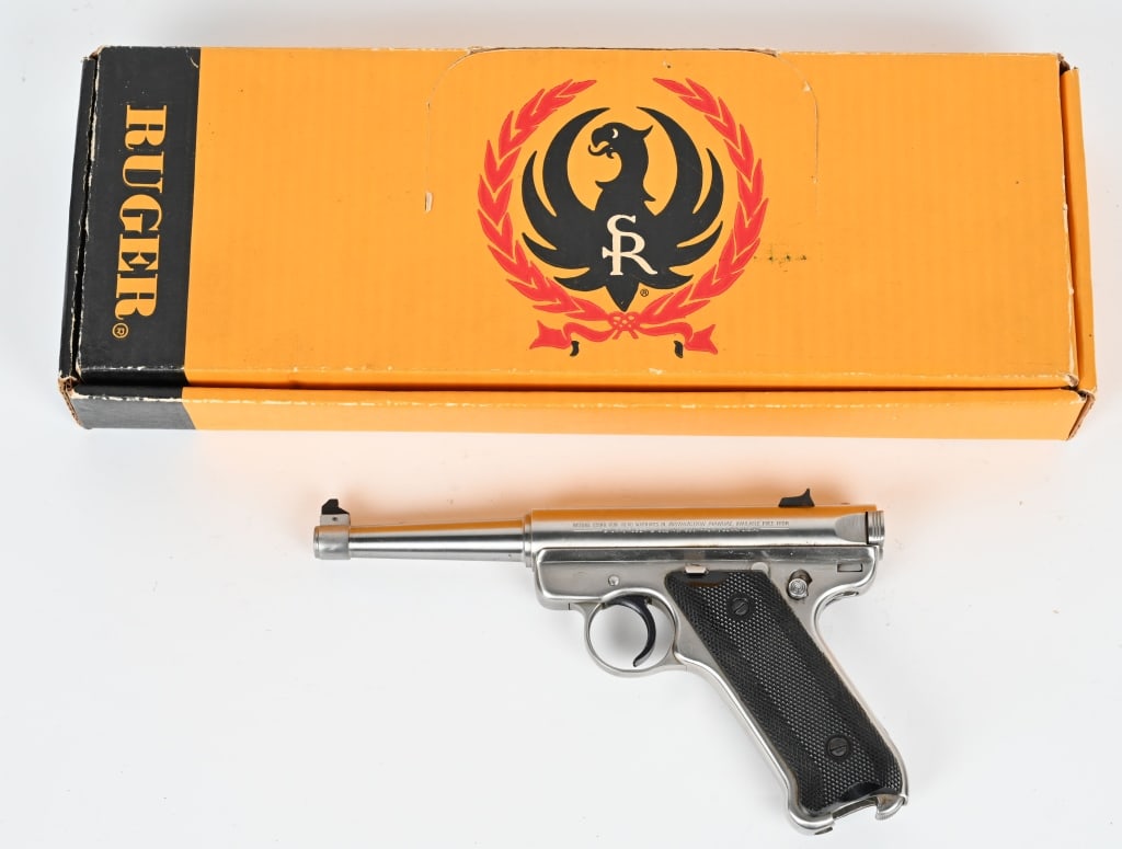 RUGER MARK II STAINLESS KMK-4 WITH FACTORY BOX: SERIAL NUMBER: 216-48138. BARREL: 4 3/4". CALIBER: 22LR. MANUFACTURED: 1990. This stainless steel Mark II has checkered grips and (2) factory magazines. Factory box and manual included. CONDITION: Pis