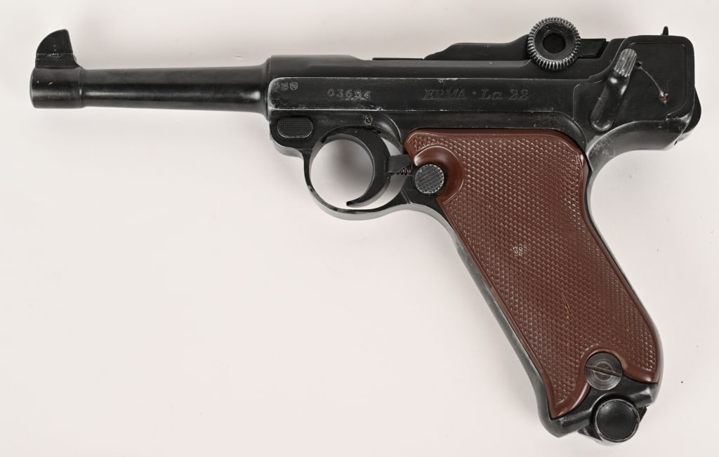 GERMAN ERMA LUGER LA22 PISTOL: SERIAL NUMBER: 03654. BARREL: 4.5". CALIBER: .22LR. MANUFACTURED: 1964. This Erfurter Maschinenfabrik (ERMA) gun is a Luger clone made to shoot the 22 long rifle cartridge, blue finish, brown plastic