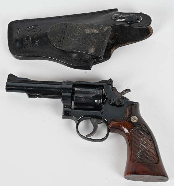 SMITH & WESSON MODEL 15-4 WITH HOLSTER: SERIAL NUMBER: 96K0463 BARREL: 4" CALIBER: 38 SPL. Revolver is Blue with heavy rusting on frame and cylinder. Case color is still present on hammer and trigger. Target style factory grips are on good