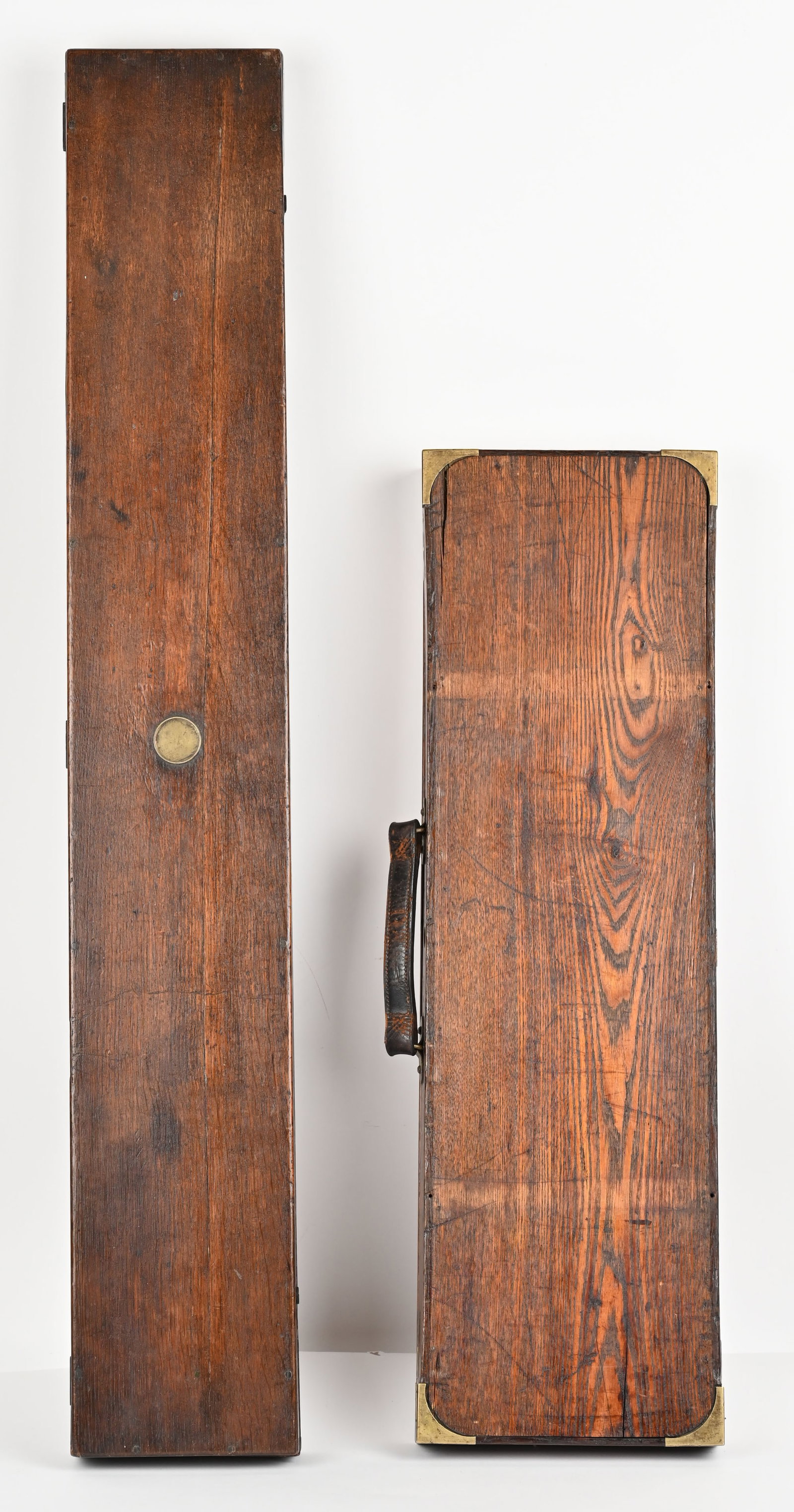 LOT OF (2) OLD TIMEY GUN CASES: This lot contains two gun cases.(1) hardwood felt lined shotgun case with brass corners. English cleaning rod, hand tools, (12) Eley London 500-3" brass shells and leather sling.(1) Deane, Adams & Dea