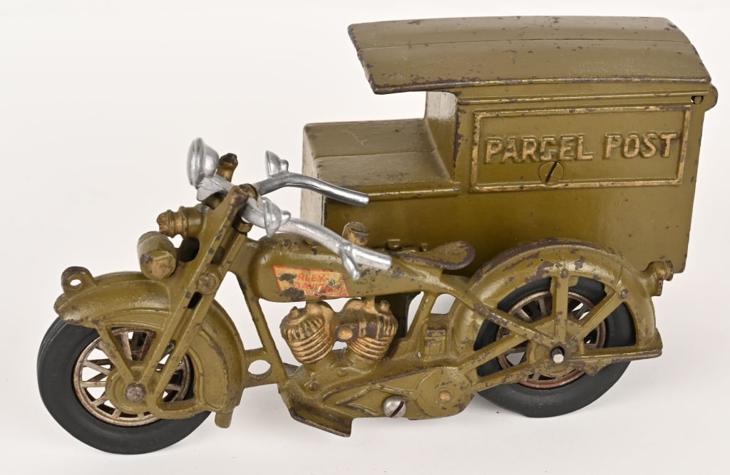 HUBLEY CAST IRON PARCEL POST MOTORCYCLE: Nice original Harley Davidson Parcel Post Motorcycle. The toy has strong original paint and most of the Harley decal on the tank. Handle bars are correct replacements. The rear door is original and th