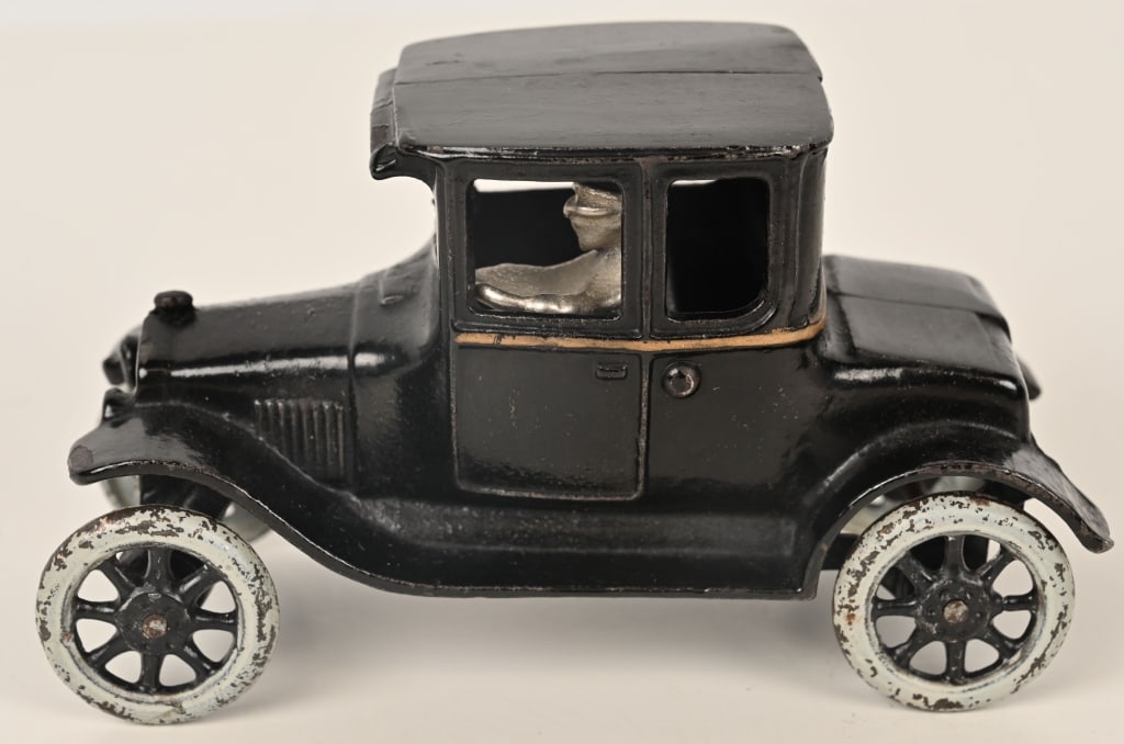 ARCADE CAST IRON MODEL T "TURTLE BACK" COUPE: Wonderful example of the 1920's Arcade cast iron Model T coupe, often referred to as the "Turtle Back". The toy is all original with no cracks or repairs. Has strong original paint and gold striping. 
