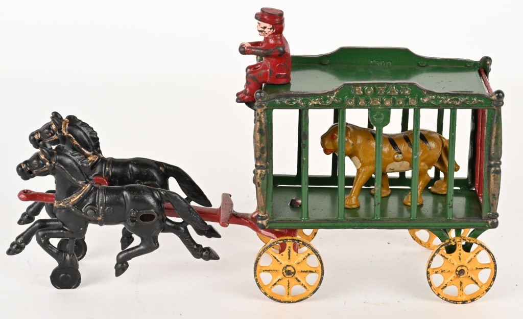 HUBLEY CAST IRON ROYAL CIRCUS WAGON w/ TIGER: Nice mid size Hubley Royal Circus horse drawn cage wagon with tiger. The toy is in nice condition and looks good under black light. The red front end does not glow, but could be repainted. Includes or
