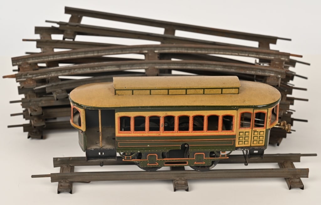 GERMAN BING CLOCKWORK TROLLEY w/ TRACK: All original Bing clockwork Trolley with reversing motor. Worked when tested. Has the Bing stamp underneath. Includes track which appears to be have the Marklin logo. 8 1/2" Excellent