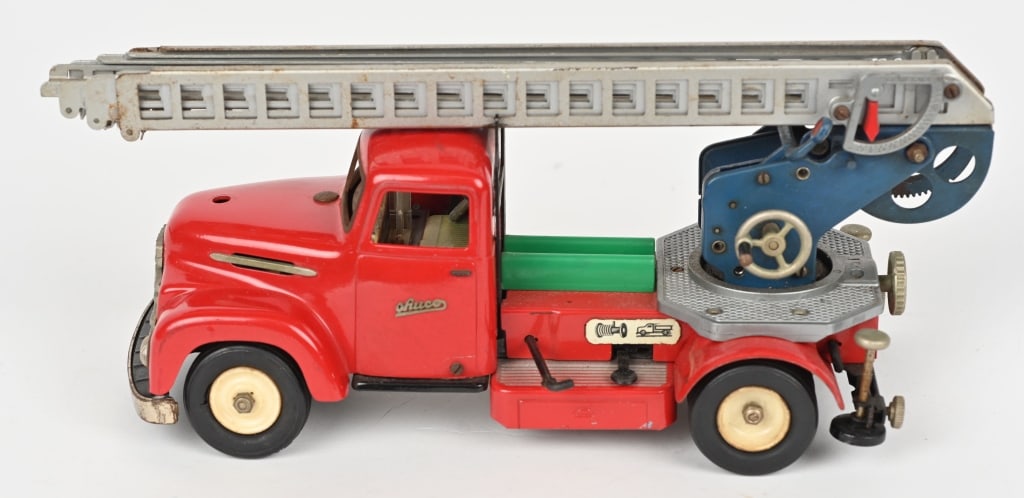 SCHUCO ELECTRIC FIRE LADDER TRUCK No. 6080: All original battery op toy. This version does not have the windup horn. Untested as battery pack is not included. Half of steering wheel is missing. 11" Excellent