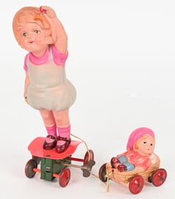 JAPAN CELLULOID WINDUP GIRL w/ CHILD IN WAGON