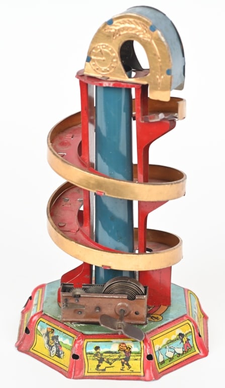 GEROGE LEVY TIN WINDUP MARBLE TOY: All original with great colors and graphics of early Automobiles, Airplanes, Black Figures, Dog, and More. Windup works. Great looking toy. 10" Excellent