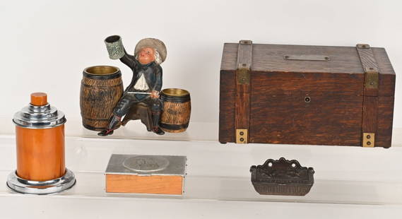 VINTAGE TOBACCIANA , HUMIDOR, MATCH SAFES & MORE: Lot includes: 1. 11" by 7" Oak humidor. 2. 7" cast metal figural Drunkard cigarette, match holder, 3. 3 3/4" cast iron Match safe with dog, Pat Jan. 21, 1862, 4. 6" Bakelite and chrome Cigarette dispe