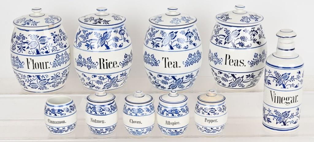 GERMAN PORCELAIN KITCHEN CANISTER SET: German 10 piece porcelain canister set. Beautiful set with some minor condition issues. Some tight hairline cracks on the larger canisters, and several lids have chips. The small Cinnamon container is