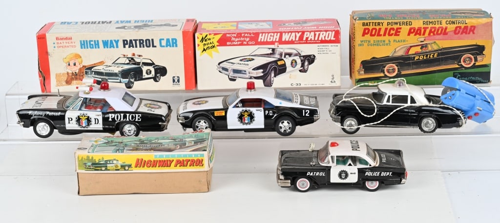 4- JAPAN TIN POLICE CARS w/ BOXES: Includes battery operated and friction cars. All in very nice condition. Boxed. Largest 11" AS-IS