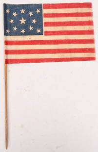 RARE SMALL 13 STAR PRINTED FLAG CIRCA 1860's: Rare Circa 1860's to 1876 13 Star American Flag with alternating 13 Red and White Stripes and a Blue Canton having 13 White Stars that is mounted on a wood dowel rod. Overall length of the flag is 9 1