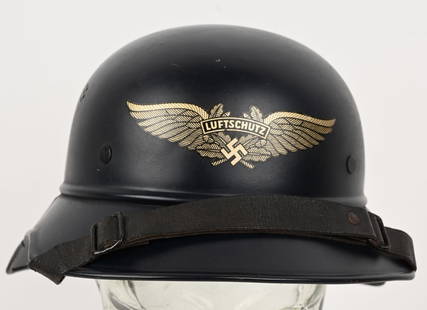 WWII NAZI LUFTSCHUTZ BEADED M38 GLADIATOR HELMET: The three piece, stamped, sheet steel construction Luftschutz M38 "Gladiator" style helmet retains a most of its original, smooth, dark satin blue paint. The front center of the helmet has a Luftschut