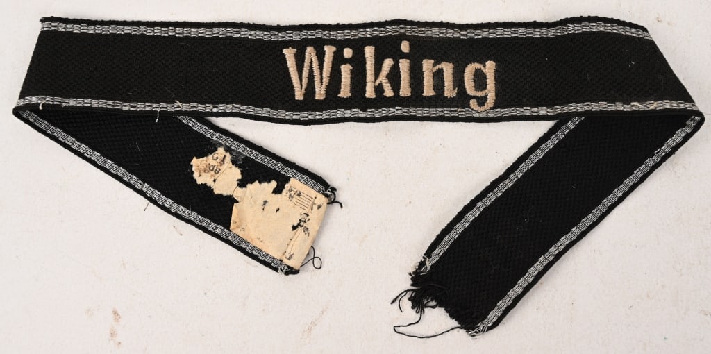 WWII NAZI GERMAN RZM WAFFEN SS WIKING CUFFTITLE: A fine and very desirable cuff title; fine quality example in RZM style embroidery treadinging of the word “Wiking” on a black embroidered background; with a horizontally embroidered silve