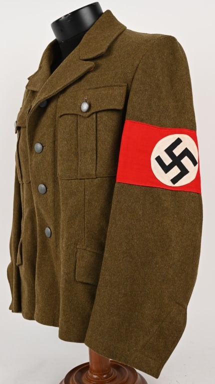 WWII NAZI GERMAN NSDAP SA WOOL SERVICE TUNIC WW2: A brown wool single-breasted Wehrmannschaft tunic. The tunic has a pleated patch pocket to each breast, both with scalloped flaps secured by a single button, and two slash hip pockets, both with flaps