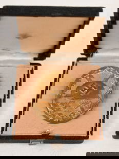 WWII NAZI GERMAN CASED GOLD WOUND BADGE WW2: 1939 pattern, die struck, alloy construction, solid backed badge with a gilt wash. The badge is in the form of an embossed, vertically oval, laurel leaf wreath encompassing an embossed profile of a M3