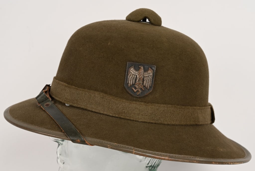 WWII NAZI GERMAN ARMY TROPICAL PITH HELMET: Second pattern pith helmet constructed in a one piece, seamless, formed, olive-drab felt crown with a horizontal band stitched at the rear center and covered by a vertical strip of felt mounted on a f
