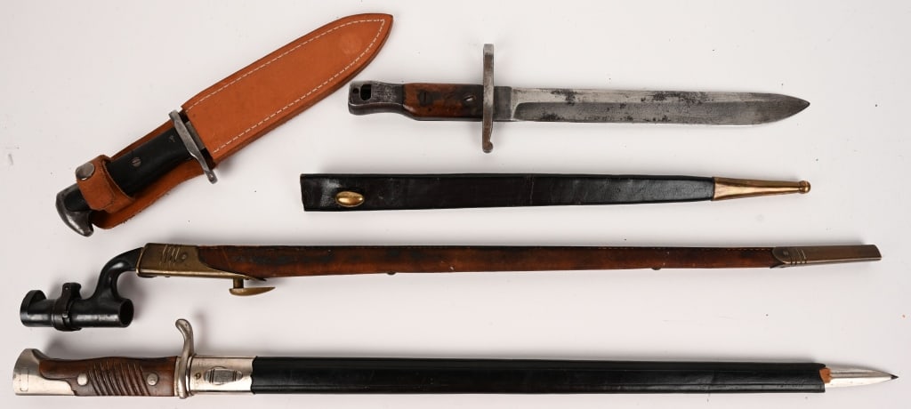 EDGED WEAPON LOT FIGHTING KNIFE BAYONETS: Lot of edged weapons to include 1) 19th Century British military Martini Henry Enfield rifle bayonet. Socket style with 22" blades, scabbard is in excellent condition, British proof marks with minor a