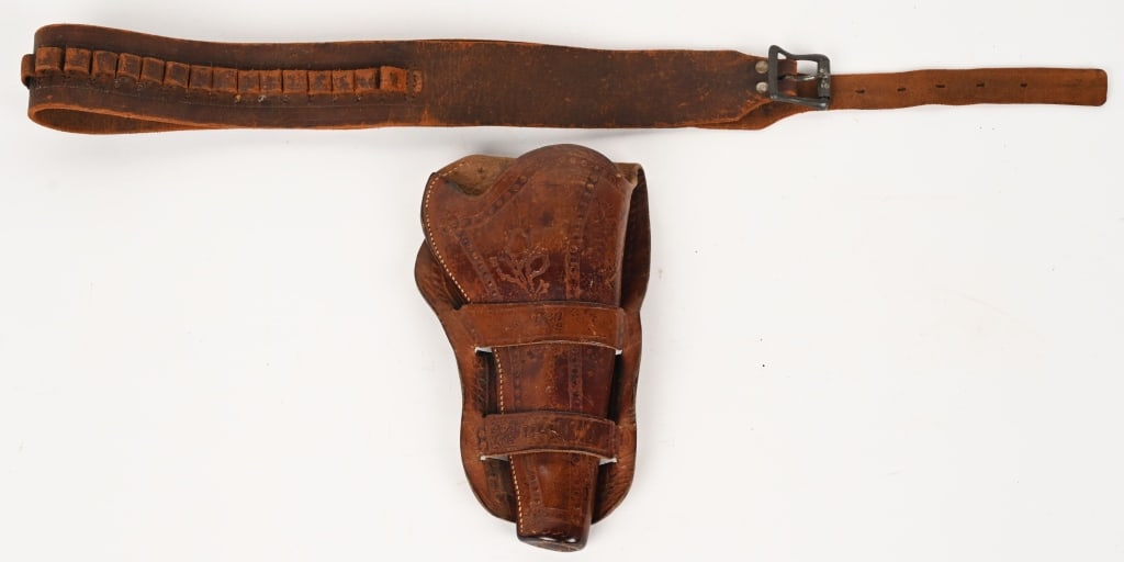 1880's OLIVE PATTERN COLT SAA HOLSTER RIG: Tooled double loop full skirt with 4 3/4" stamped on top loop and model 114 stamped on lower loop. Cheyenne style with swell and sewn toe plug. Early roller buckle belt for 44/45 caliber.
