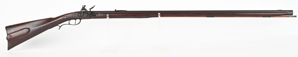 SOUTHERN MOUNTAIN STYLE FLINTLOCK KENTUCKY RIFLE: SERIAL NUMBER: NSN. BARREL: 41". CALIBER: .40. Features full length octagon barrel marked "J. Schultz" on flat, iron hardware, carved walnut stock with wood sliding patchbox. CONDITION: Very Good, Mos