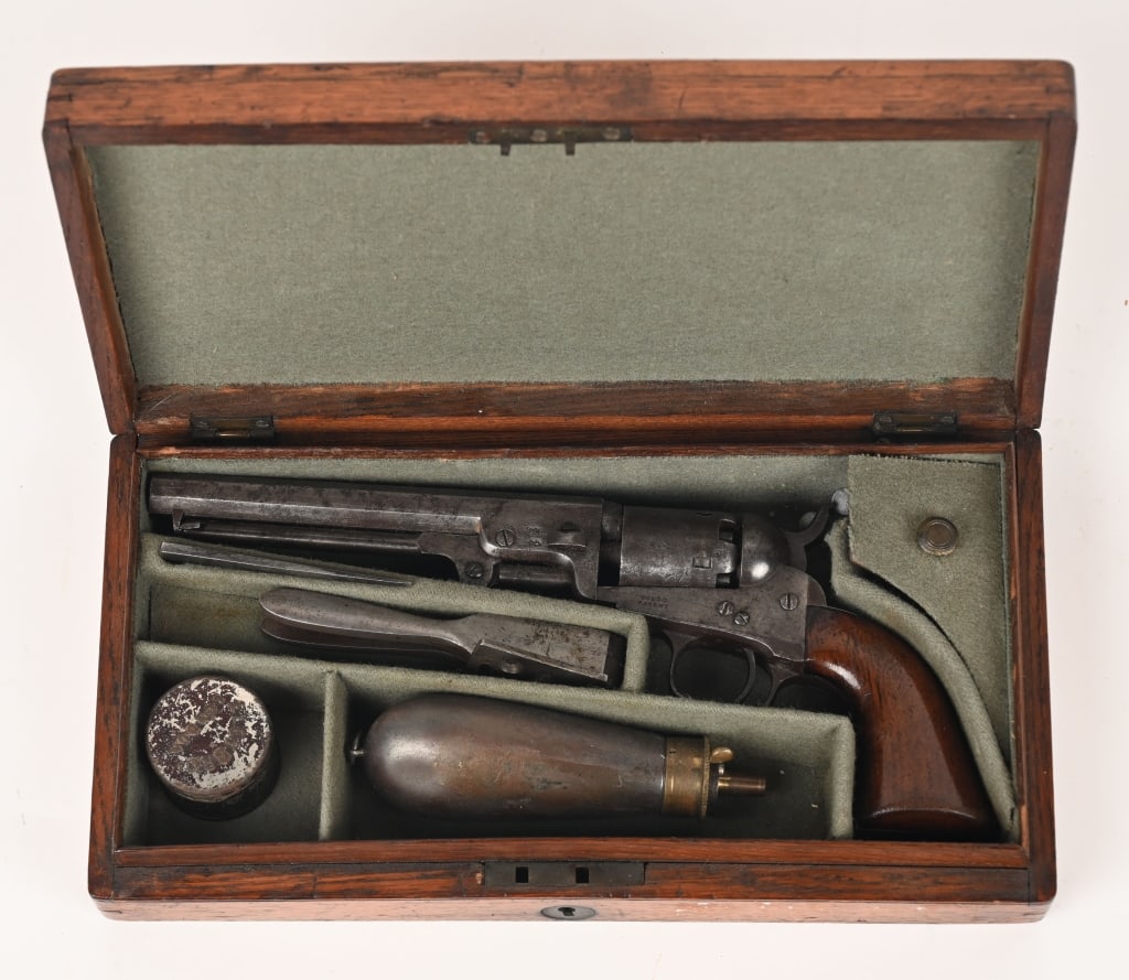 LONDON CASED COLT MODEL 1849 POCKET REVOLVER: SERIAL NUMBER: 1413. BARREL: 6". CALIBER .31. MANUFACTURED: 1854, London. Colt Model 1849 pocket revolver with British proof marks on left side of barrel and on each cylinder. Matching serial numbers