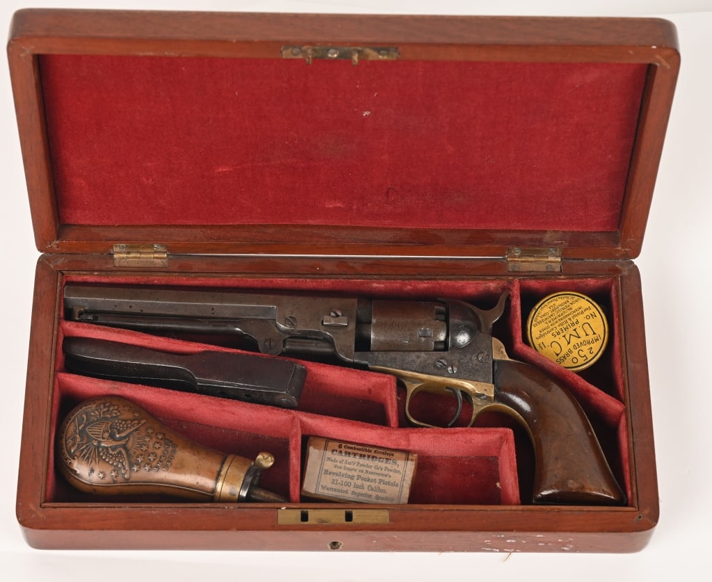 CASED COLT MODEL 1849 COLT POCKET MODEL REVOLVER: SERIAL NUMBER: 295627. BARREL: 6". CALIBER .31. MANUFACTURED: 1867. Colt Model 1849 Pocket Model and accessories. Has octagon barrel, brass trigger guard and back strap. Has New York address on barrel