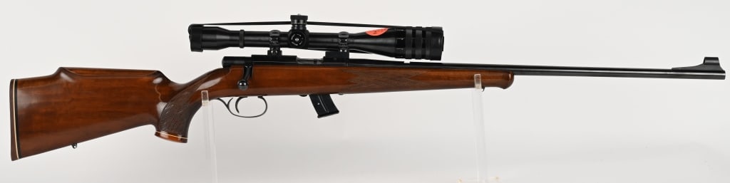 SAVAGE ANSCHUTZ MODEL 54 SPORTER RIFLE W/SCOPE: SERIAL NUMBER: 1066087A. BARREL: 24". CALIBER: .22 LR. MANUFACTURED: 1963-1981. The made in West Germany, the model 54 Sporter bolt action rifle features blued round barrel and receiver, hooded ramp f