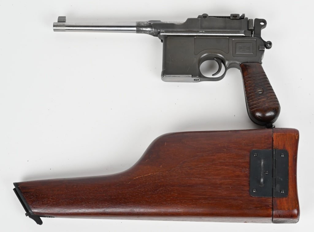MAUSER C96 BROOM HANDLE WITH STOCK 7.63 MM: SERIAL NUMBER: 859128 BARREL: 5 1/2" CALIBER: 7.63 MM MANUFACTURED: 1932 Made in Germany. Metal is gray phosphate finish with standard sights and wood grips. It comes with reproduction wood stock. CON
