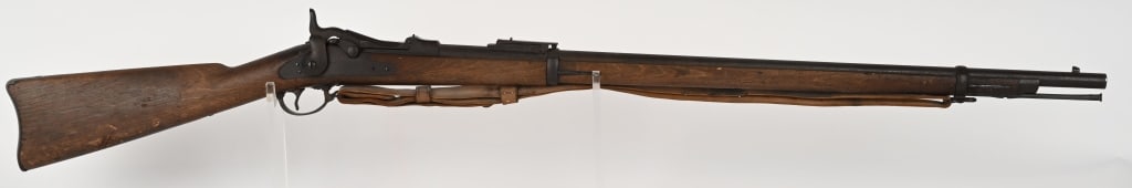 US MODEL 1884 TRAPDOOR SPRINGFIELD RIFLE: SERIAL NUMBER: 335580. BARREL 32 5/8". CALIBER 45-70. It features two barrel bands, nose cap, cleaning rod and Buffington rear sight. Has rear sling swivel, front stacking swivel and nice leather slin