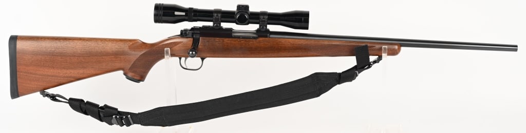 RUGER 77 / 22 BOLT ACTION RIFLE WITH SCOPE 22 MAG: SERIAL NUMBER: 701-57732. BARREL: 20". CALIBER: 22 MAG. MANUFACTURED: 1993. Metal is blued steel with no sights. Wood is oil finished walnut. Tasco Golden Antler 4x32 is mounted. CONDITION: Metal is 9