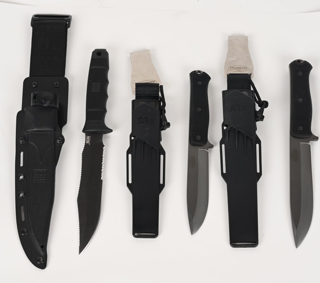 FÄLLKNIVEN KNIFE LOT S1X A1X SOG SHEATHED KNIVES: Lot of three Sheathed Knives to include 1) SOG Seal Team Elite Fixed Blade Knife With Sheath. Blade measures 7 inches. MINT! SOG was named in honor of a covert US Special Ops unit – MACV-SO