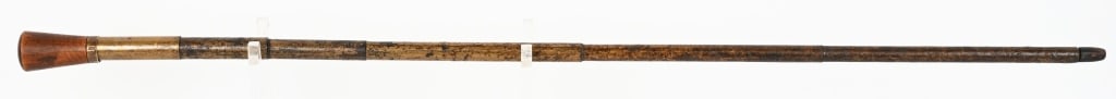 ANTIQUE CANE GUN: SERIAL NUMBER: N/A, BARREL: 27", CALIBER: about .36, Antique cane gun measuring 34 1/2" overall. Includes original barrel plug. Brass ring by the wood pommel is marked "George 1884 Reed". It also appe