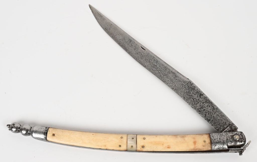 LARGE 19th CENTURY SPANISH NAVAJA FOLDING KNIFE: Large 19th century Spanish Navaja foldin knife. The knife is 27 1/4" overall with a 13" blade. When opened the blade locks into place. When closed the knife measures about 14 1/2" The grips are bone d