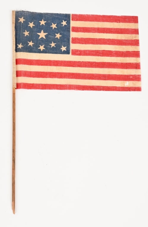 RARE SMALL 13 STAR PRINTED FLAG CIRCA 1860's: Rare Circa 1860's to 1876 13 Star American Flag with alternating 13 Red and White Stripes and a Blue Canton having 13 White Stars that is mounted on a wood dowel rod. Overall length of the flag is 9 1