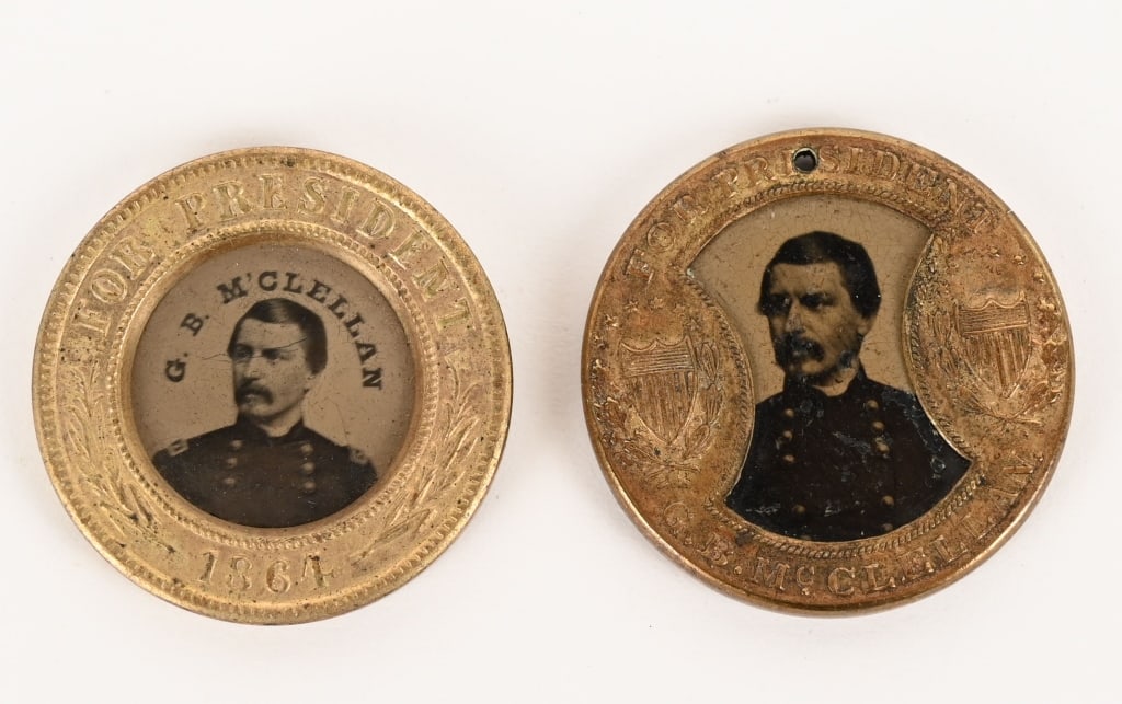 CIVIL WAR POLITICAL 1864 BUTTONS GEORGE MCCLELLAN: Lot of two, George McClellan Ferrotype Political pins to include 1) Scarce George McClellan and James Pendleton Ferrotype, 1864. Double-sided political badge, 25 mm., containing tintype portraits of G