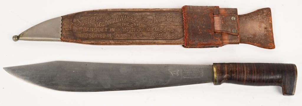 COLLINS #254 KNIFE SPAN AM WAR DEDICATION VETERANS: Measuring 17 inches overall, with a 12 1/4 inch straight clip blade, with the Collins markings stamped on the left side and a Collins paper label attached to the reverse. The grip is of leather washer