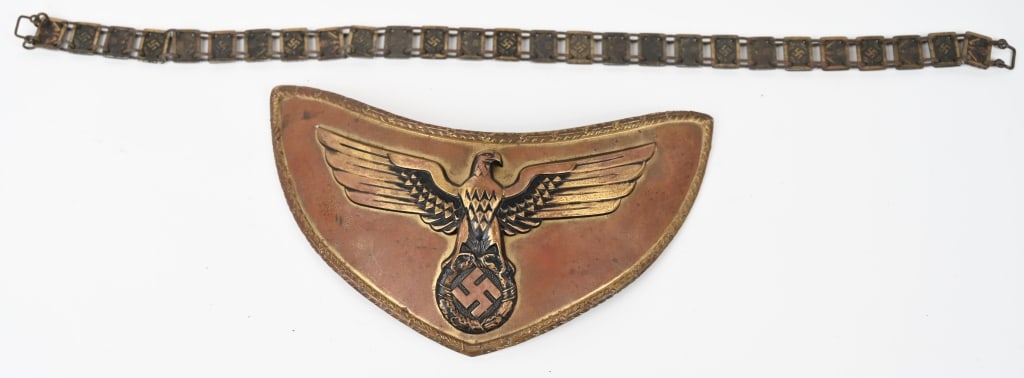WWII NSDAP POLITICAL LEADER FLAG BEARER'S GORGET: Stamped alloy gorget with a bronze wash. The half-moon shaped gorget measures roughly, 24cm wide from upper tip to tip and 12cm tall. The gorget features a separate, stylized, bronze washed, embossed