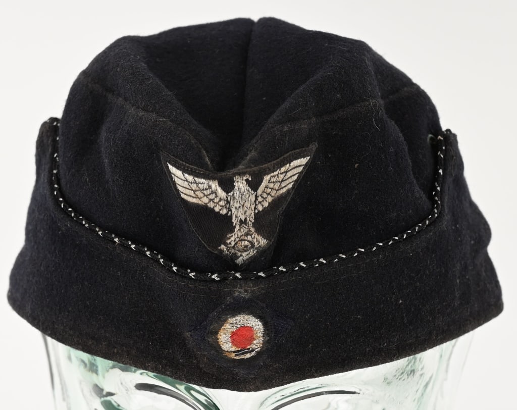 WWII NAZI GERMAN TENO OFFICERS OVERSEAS CAP WW2: Dark navy blue wool/rayon blend cap, with fold down scalloped sides. Sides have stitched in hooks to slip through metal grommets on cap body sides. Machine woven TeNo insignia in silver/aluminum threa