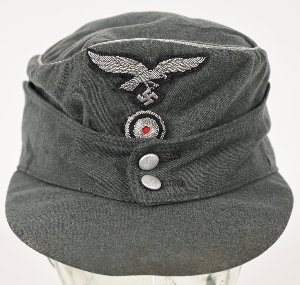 WWII NAZI GERMAN LUFTWAFFE FIELD DIVISION M43 CAP: Nice quality, green wool/rayon, blend construction cap, features fold down side and back panels with a scalloped front with two silver washed, pebbled, sheet metal button closure at the front center. 