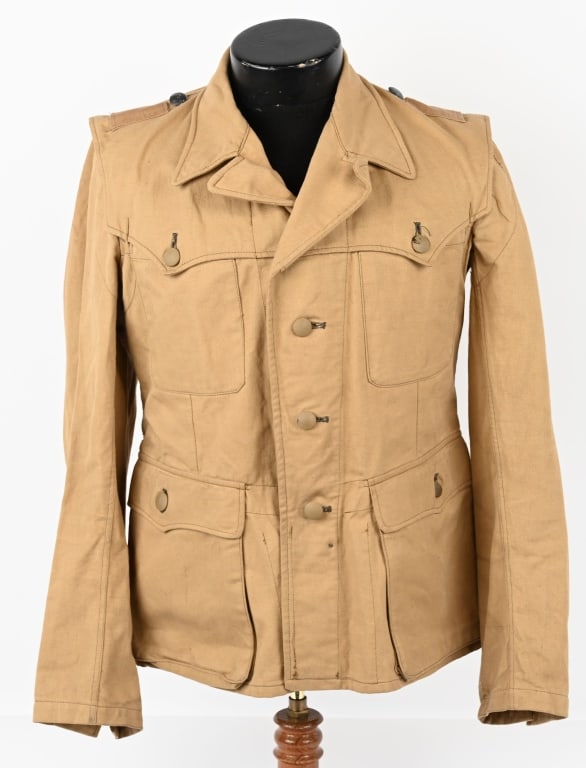 WWII NAZI WAFFEN SS TROPICAL SERVICE TUNIC WW2: Light-weight subtly ribbed tan cotton twill construction tropical "Sahariana" style field blouse features a vertical four button front closure with small fold back lapels and a lay down collar. The fi