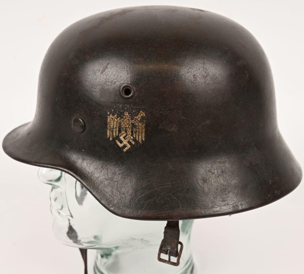 WWII NAZI GERMAN M40 SINGLE DECAL HELMET ET64 WW2: The stamped, sheet steel construction helmet retains about 85% of its green paint. The left side of the helmet has an Wehrmacht eagle shield decal featuring a eagle with down-swept wings, clutch