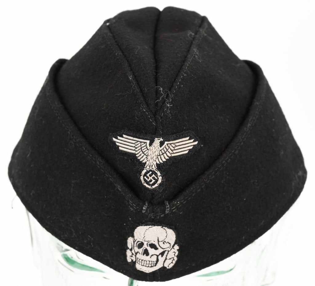 WWII NAZI GERMAN WAFFEN SS PANZER M40 OVERSEAS CAP: Black wool/rayon blend construction M40 overseas cap with fold down side and back panels that slope gently downwards to the front center. The front center of the cap has a second pattern, (circa 1936)