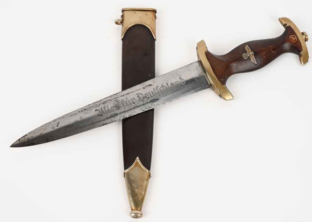 WWII NAZI GERMAN SA DAGGER BY TIGER WW2: Double edged, nickel/silver plated blade with a low central ridge. Blade is in overall good condition with original cross-graining still visible. Shows the normal scabbard runner marks and typical lig