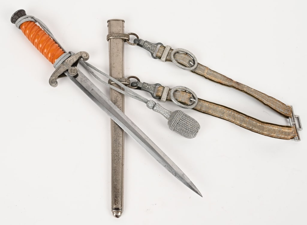 WWII NAZI GERMAN ARMY OFFICER DAGGER W HANGERS WW2: German WWII Army Officers Dagger & Scabbard with Hangers. Measures 15 9/16" long overall. The steel blade is maker marked 'A. W. Jr Solingen' (Anton Wingen Jr). Has their knight logo in the center. In