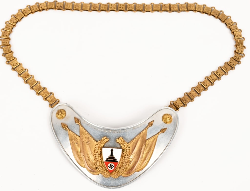 WWII NAZI GERMAN DRKB FLAGBEARER'S GORGET NAMED: Very nice early (circa 1937) multi-piece stamped polished natural aluminum construction heart shaped gorget base with a separate fire gilted and multi-colored enamel work faceplate. All complete and i
