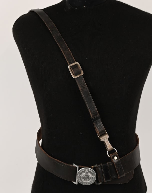 WWII NAZI SS OFFICER'S LEATHER BELT & BELT BUCKLE: Silver washed, die struck, aluminum alloy construction, circular belt buckle features a high relief, stylized, national eagle with outstretched, downward curving, wings, clutching an oak-leaf wreath w