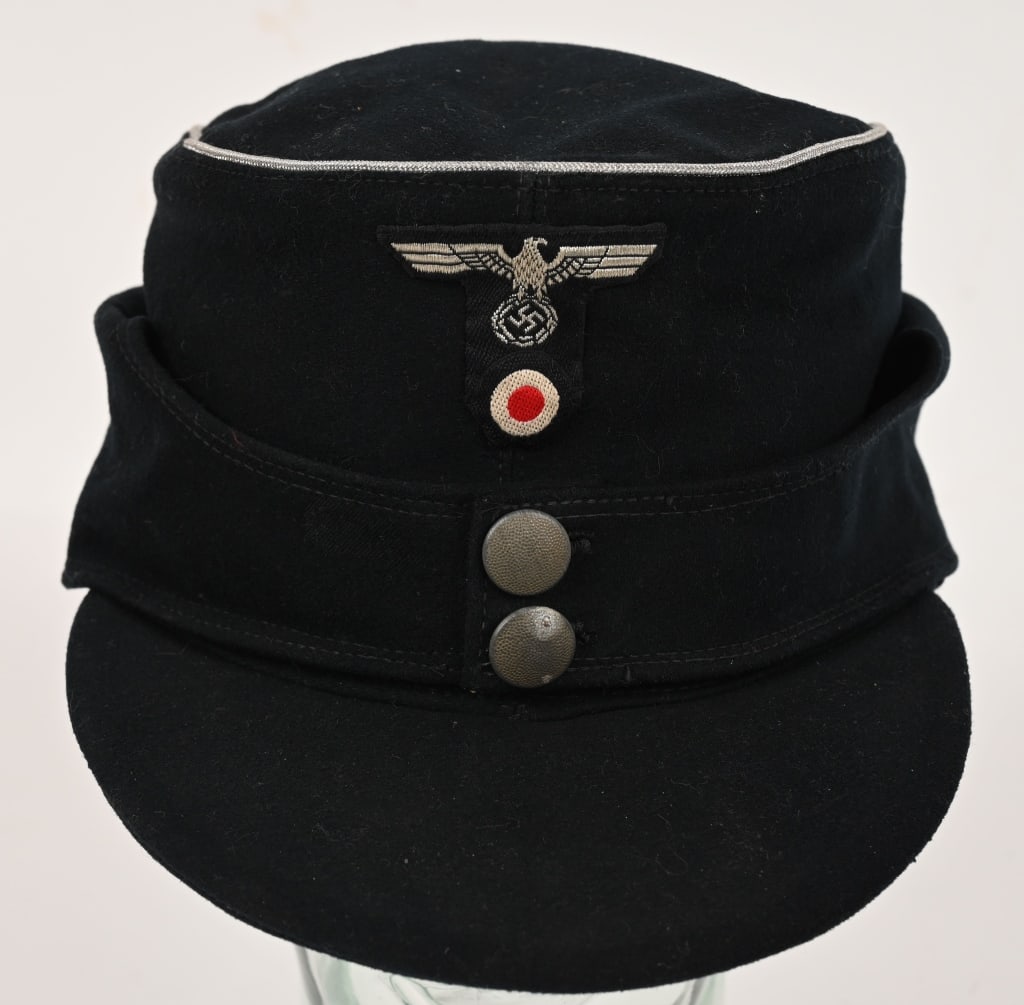 WWII NAZI GERMAN PANZER OFFICERS M43 CAP OR HAT: Nice quality black wool construction cap features fold down back and side panels with a downward scalloped front edge and forward sides and two small blackened magnetic buttons. The back and side pane