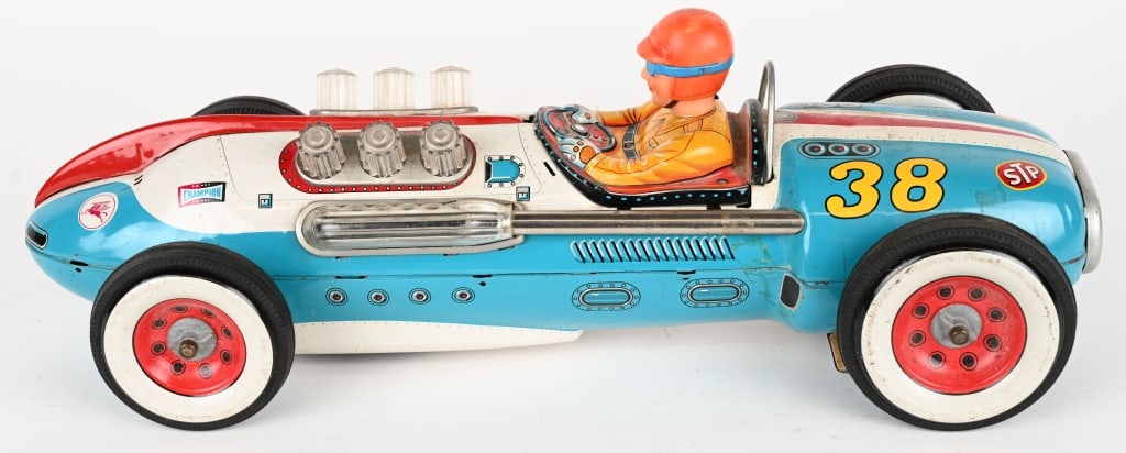 JAPAN BATTERY OP #38 RACE CAR: Large impressive toy. All original with nice graphics. Did not work when tested. Missing battery door latch. 18" Excellent