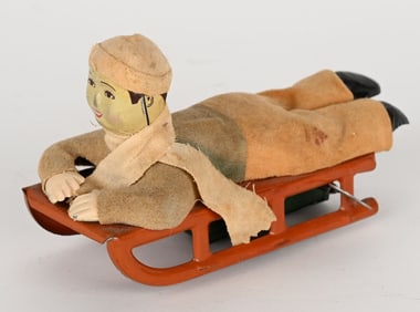 JAPAN TIN WINDUP BOY ON SLED