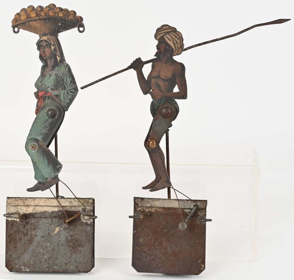 2- GERMAN ARAB WALKER BALANCE TOYS: German Arab Man with Spear and Woman with Fruit Balance Toys. Very unusual toys that are well made with nice details. These were made to balance on a rope and look like the figures are walking. A rare