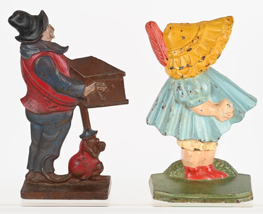 ORGAN GRINDER & SUN BONNET GIRL DOOR STOPS: Pair of cast iron door stops. Both all original in great shape. Largest 10" Excellent